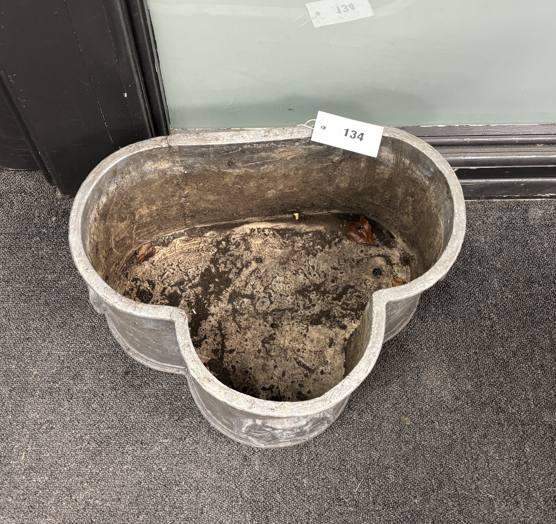 A lead trefoil shaped garden planter, with applied Tudor roses width width 40cm, depth 30cm, height 22cm.